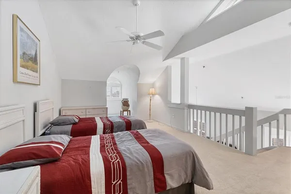 a bedroom with two beds and a chandelier