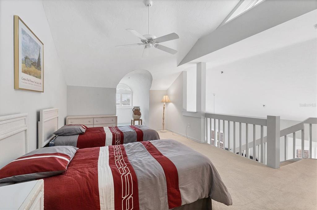 11000 Placida Road, Unit 1604 Placida, FL 33946 - Photo 25 of 42 a bedroom with two beds and a chandelier