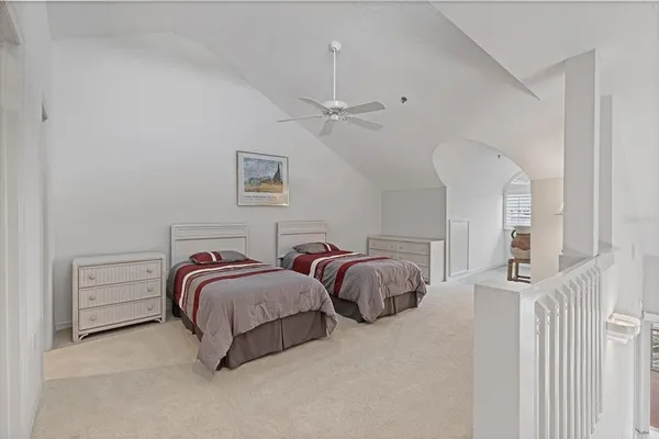 a bedroom with two beds and a chandelier