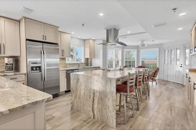 a kitchen with a sink cabinets stainless steel appliances and a window