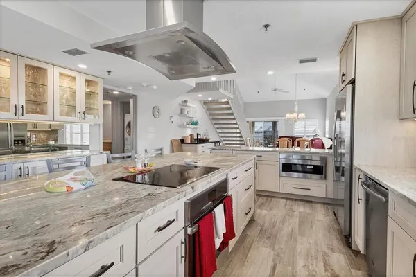 a kitchen with stainless steel appliances granite countertop a sink and stove