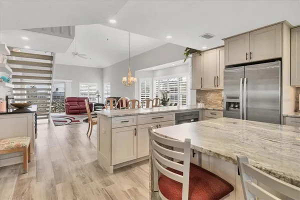 a kitchen with stainless steel appliances granite countertop a stove refrigerator and cabinets