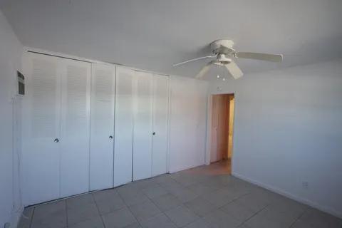 1050 East Sample Road, Unit 101 Pompano Beach, FL 33064 - Photo 13 of 19 a view of a closet in a room