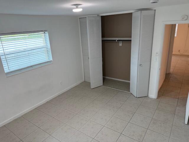 1050 East Sample Road, Unit 101 Pompano Beach, FL 33064 - Photo 13 of 24 a view of an empty room with a kitchen