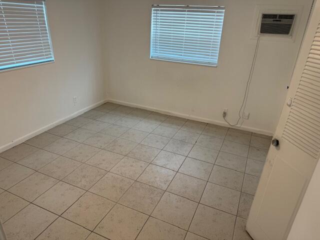 1050 East Sample Road, Unit 101 Pompano Beach, FL 33064 - Photo 16 of 24 a view of an empty room with a window