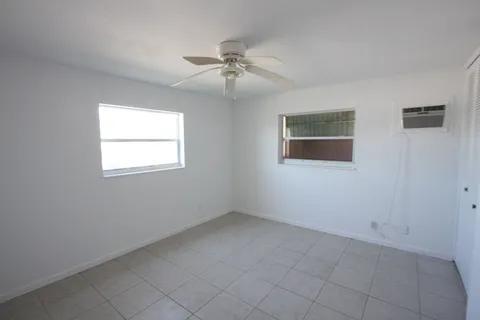 1050 East Sample Road, Unit 101 Pompano Beach, FL 33064 - Photo 16 of 19 an empty room with a window