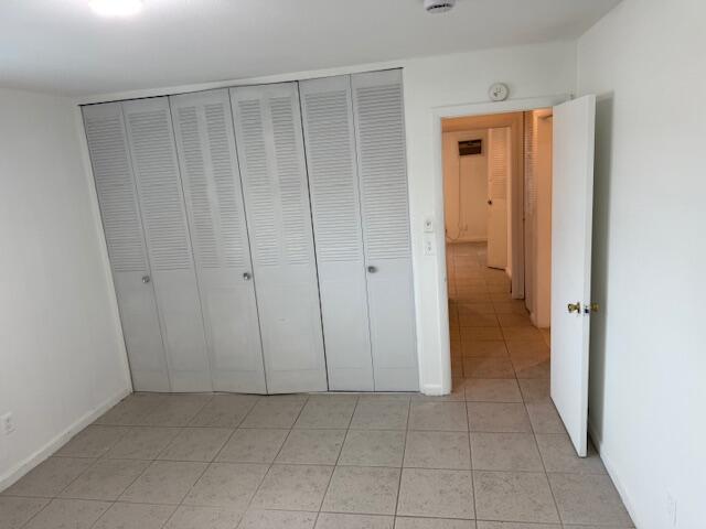 1050 East Sample Road, Unit 101 Pompano Beach, FL 33064 - Photo 17 of 24 a view of a closet area with hardwood floor