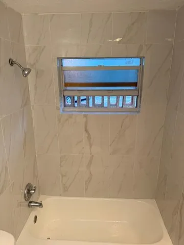 a bathroom with a toilet sink and a mirror