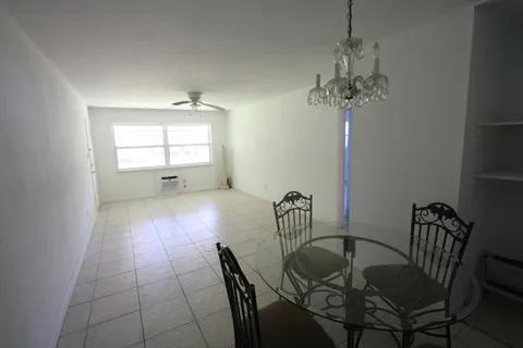 1050 East Sample Road, Unit 101 Pompano Beach, FL 33064 - Photo 3 of 19 a view of a dining room with furniture and window
