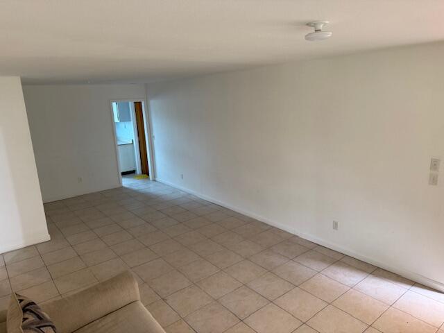 1050 East Sample Road, Unit 101 Pompano Beach, FL 33064 - Photo 4 of 24 a view of an empty room and window