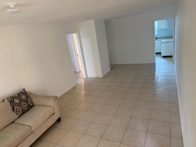 1050 East Sample Road, Unit 101 Pompano Beach, FL 33064 - Photo 6 of 24 a living room with furniture and a walk in closet