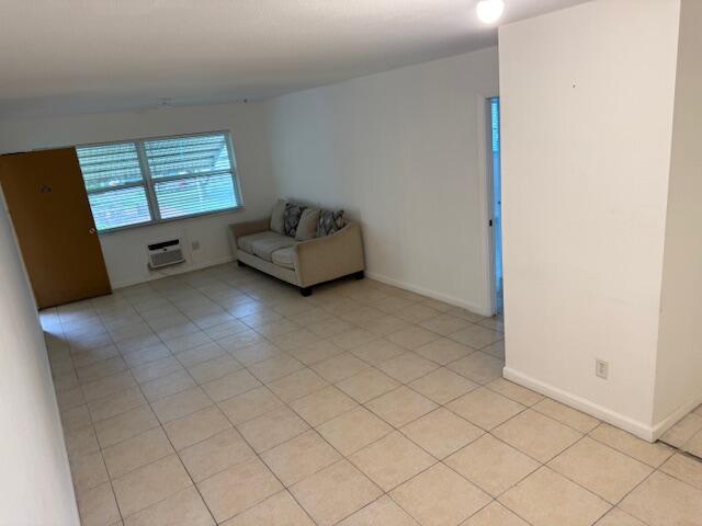 1050 East Sample Road, Unit 101 Pompano Beach, FL 33064 - Photo 7 of 24 a living room with furniture and a window