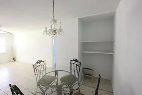 a view of a dining room with furniture and a chandelier