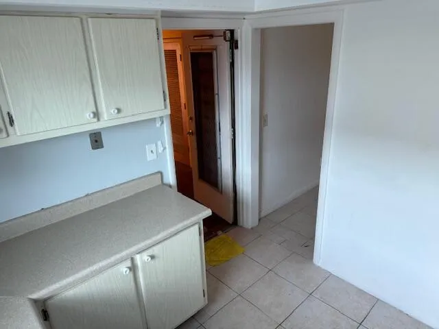 a view of storage and utility room with closet
