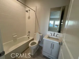 a bathroom with a sink a toilet a mirror and bathtub