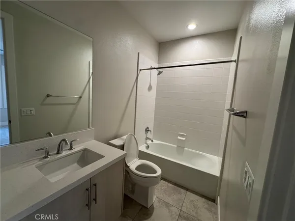 a bathroom with a granite countertop sink toilet a shower and a mirror