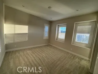 a view of an empty room and a window