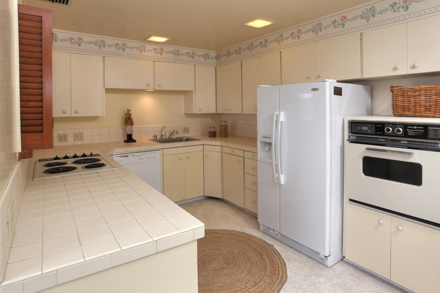 1605 Paterna Road Santa Barbara, CA 93103 - Photo 13 of 26 a kitchen with a sink a stove a refrigerator a center island and cabinets