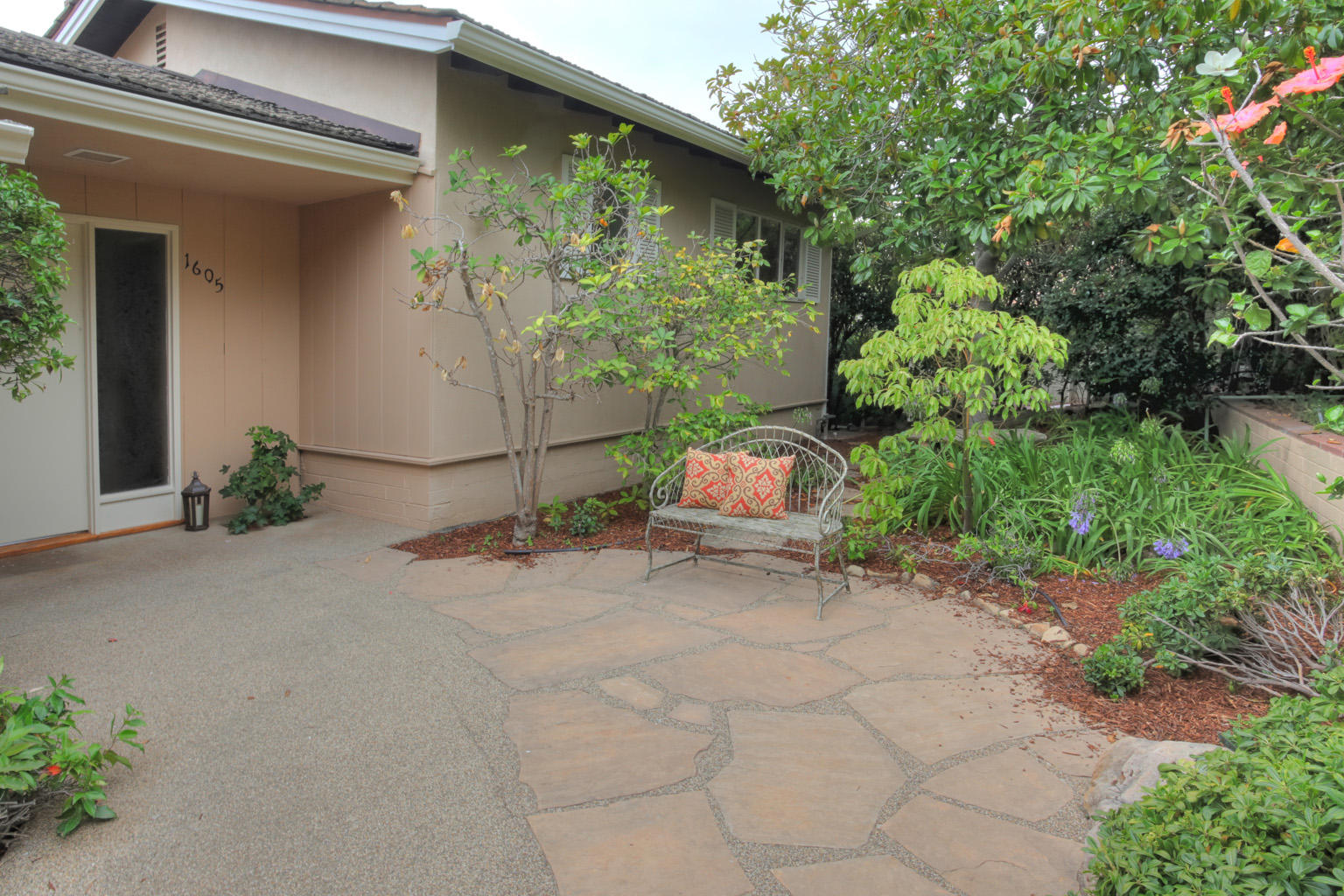 1605 Paterna Road Santa Barbara, CA 93103 - Photo 6 of 26 a backyard of a house with lots of green space and glass windows
