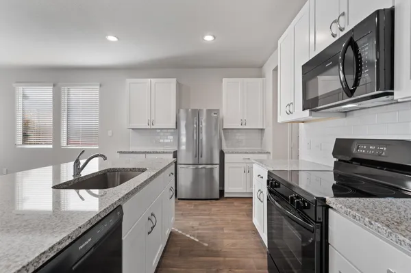 a kitchen with a sink stove and refrigerator