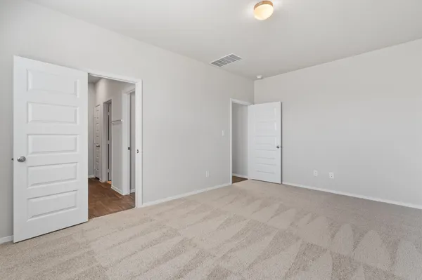 a view of an empty room and closet area