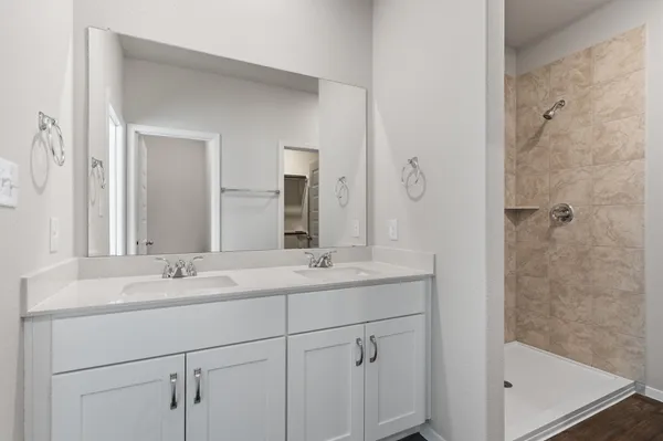 a bathroom with a shower sink and mirror