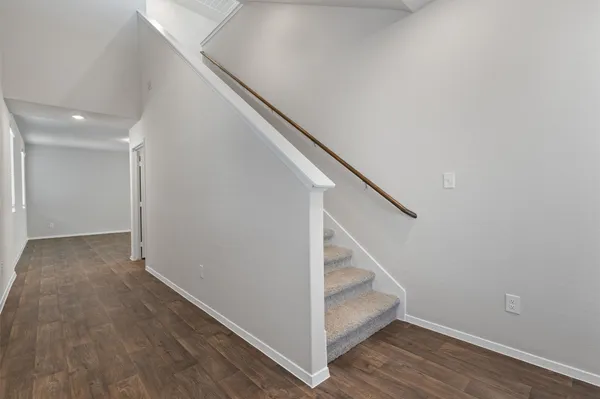 a view of entryway and hall with wooden floor