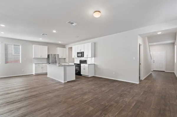 a view of kitchen with wooden floor and electronic appliances