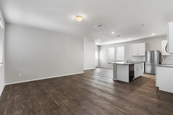 a view of kitchen with kitchen island and stainless steel appliances