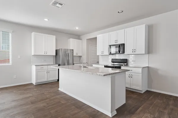 a kitchen with white cabinets and white appliances