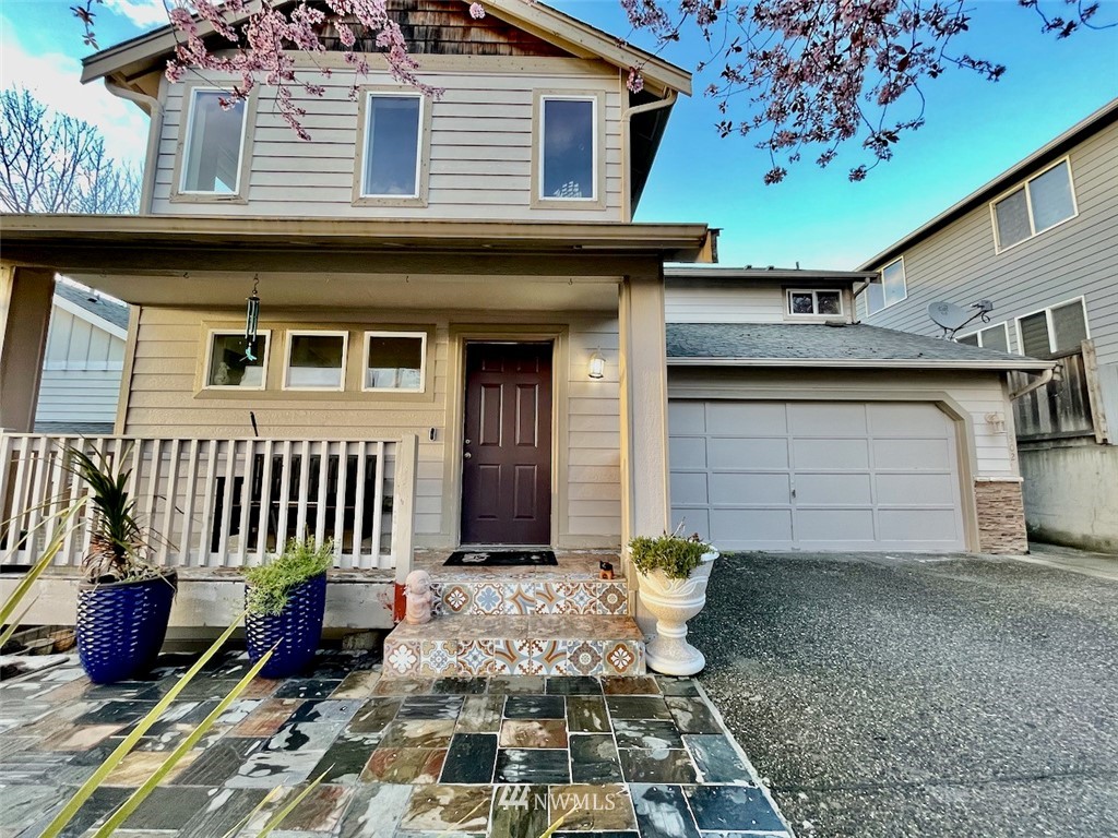 502 South 53rd Place Renton, WA 98055 - Photo 2 of 23 a front view of a house with a garage