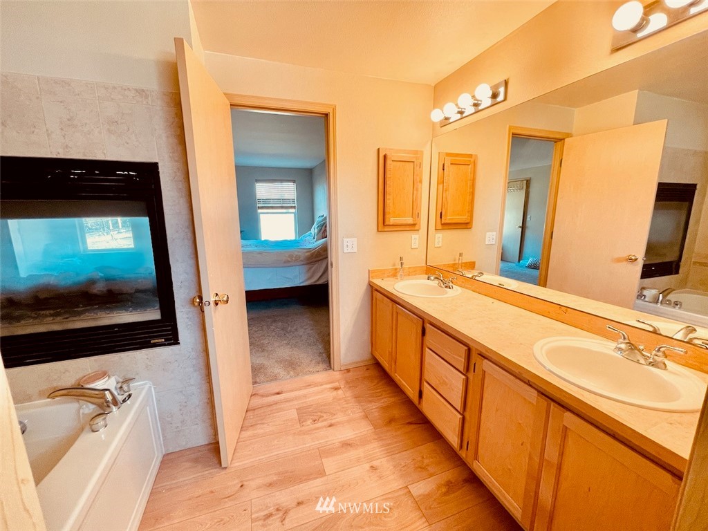 502 South 53rd Place Renton, WA 98055 - Photo 17 of 23 a spacious bathroom with a tub a double vanity sink and a mirror