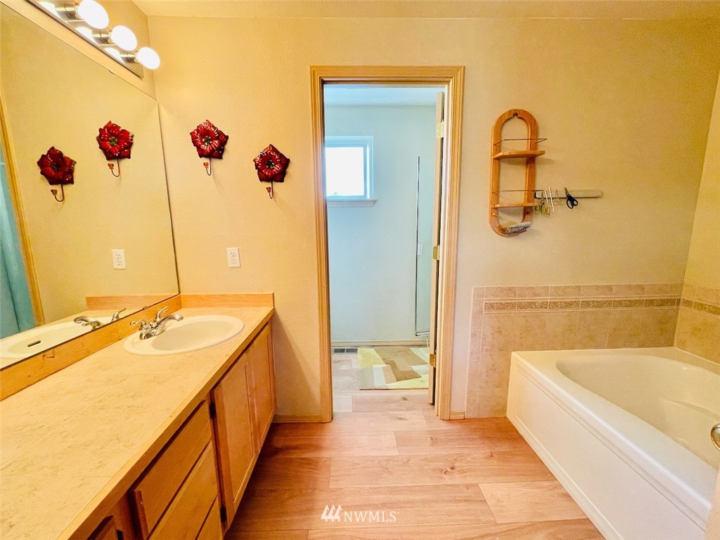 502 South 53rd Place Renton, WA 98055 - Photo 18 of 23 a bathroom with a tub sink and mirror