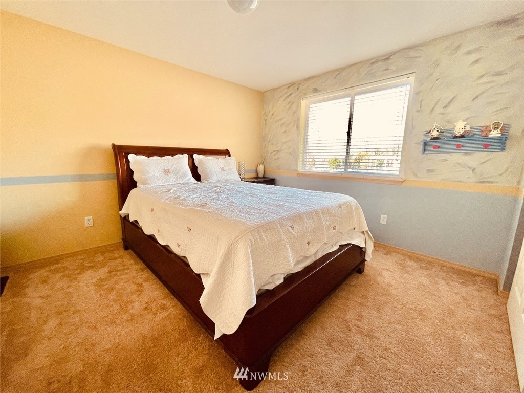502 South 53rd Place Renton, WA 98055 - Photo 20 of 23 a bed sitting in a bedroom next to a window