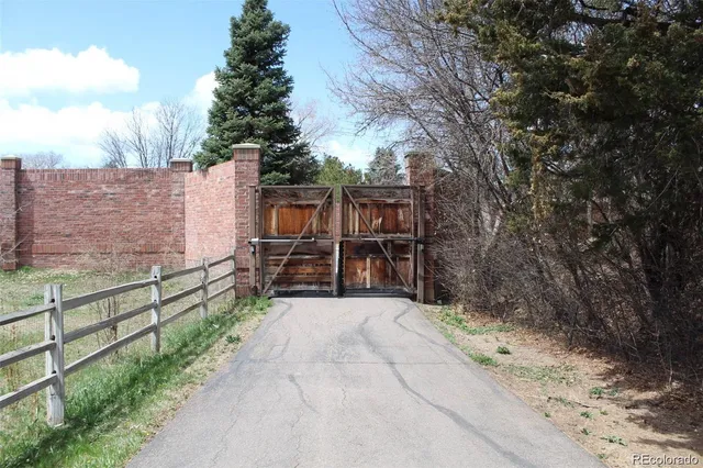 a view of a pathway with a wrought fence