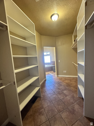 140 North 200 E Street Glenwood, UT 84730 - Photo 23 of 54 Walk in closet featuring dark tile patterned floors