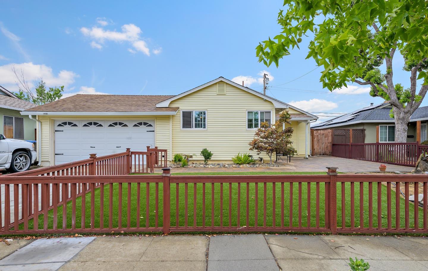 a front view of a house with a garden