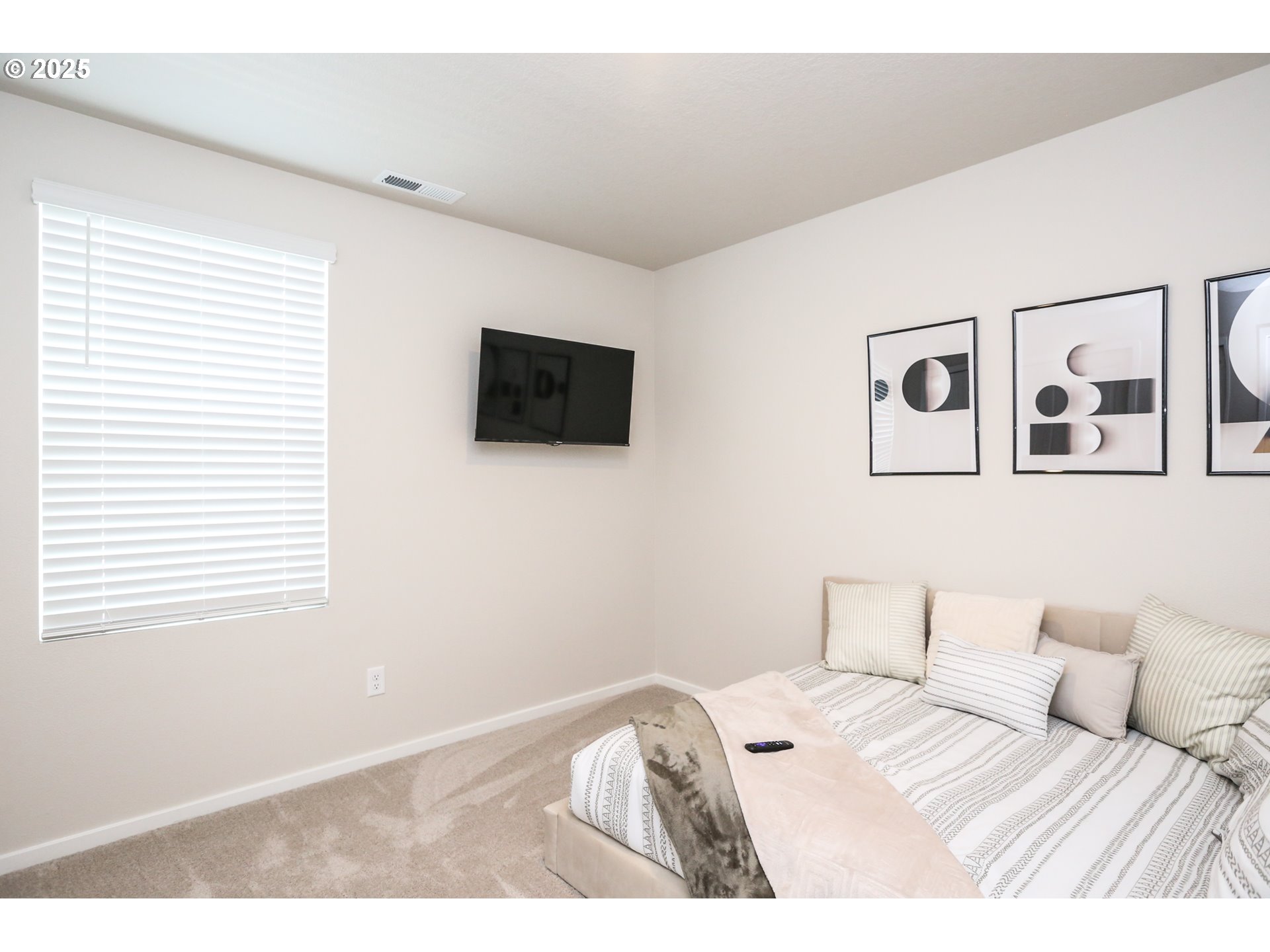 2685 V Street Springfield, OR 97477 - Photo 17 of 22 a bedroom with a bed and a flat screen tv