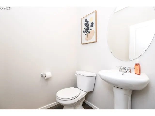 a bathroom with a sink mirror and toilet