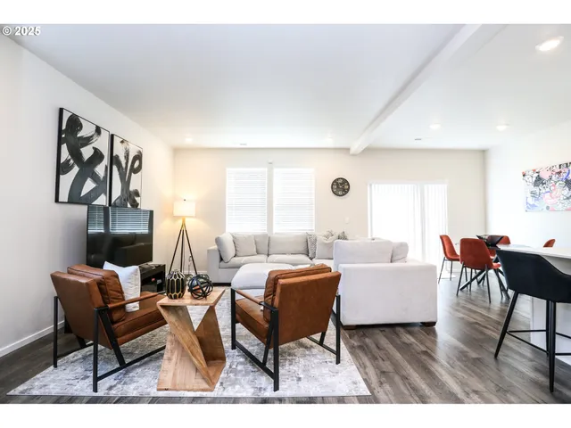 a living room with furniture a rug and a table