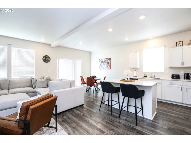 a living room with furniture a wooden floor and a window