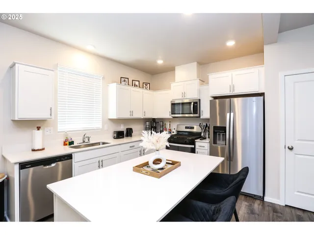 a kitchen with refrigerator a stove a sink dishwasher and a refrigerator