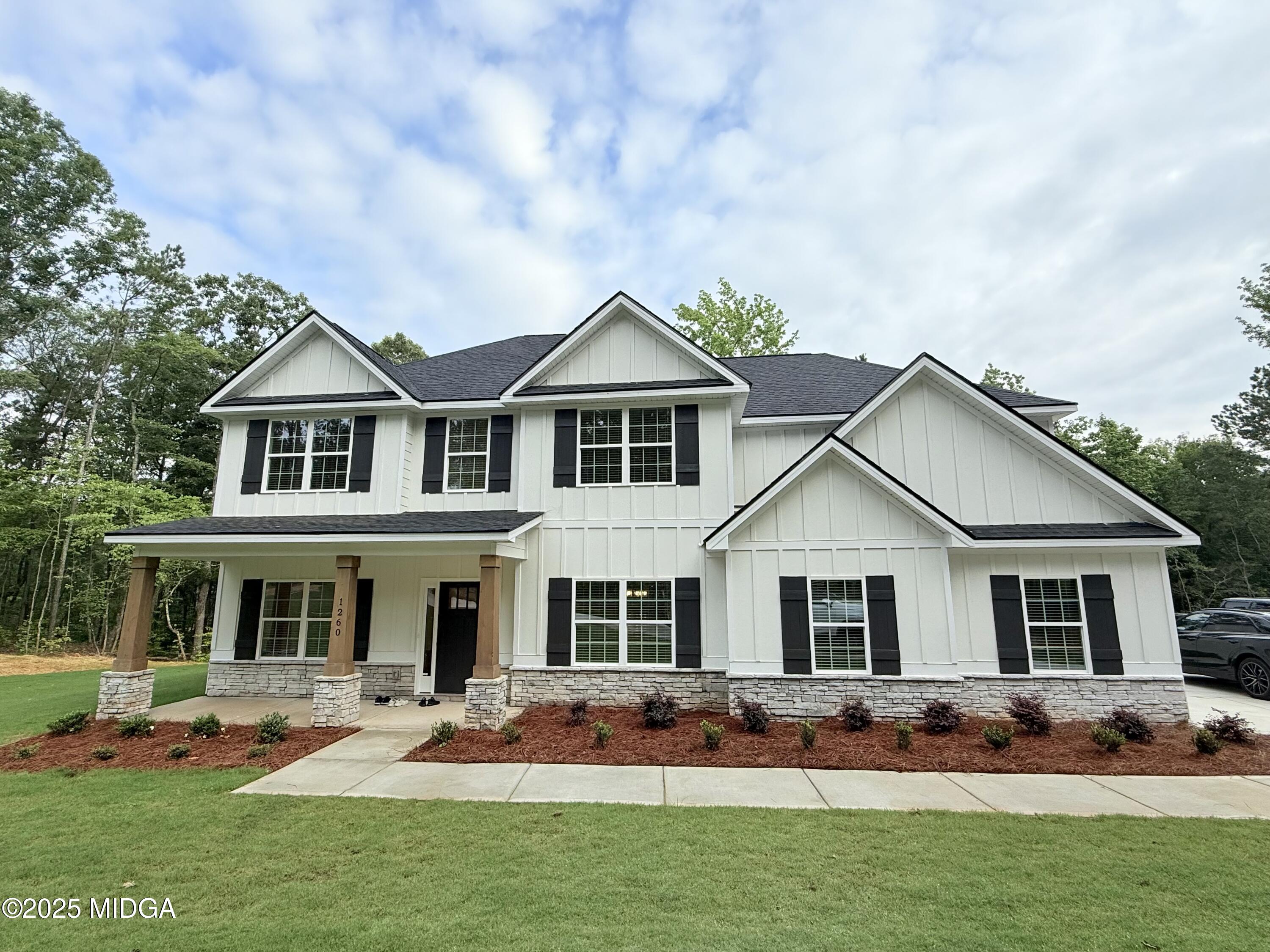 1260 Teagle Road, Unit 8 Forsyth, GA 31029 - Photo 1 of 1 a front view of house with yard outdoor seating and yard in front of it