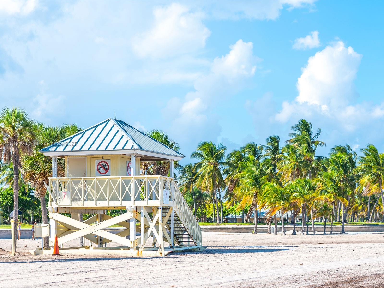 77 Crandon Boulevard, Unit 10A Key Biscayne, FL 33149 - Photo 12 of 15 a front view of a house with a yard