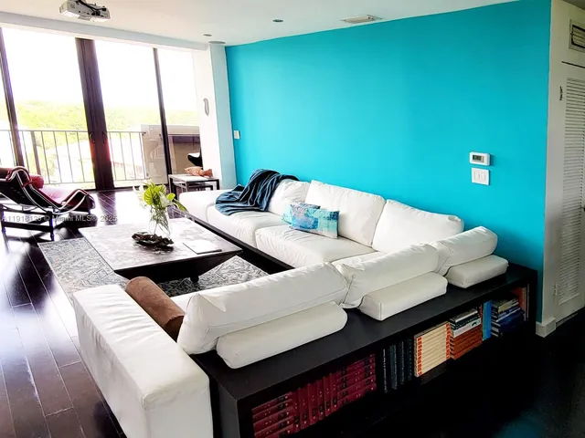 a living room with furniture and large window