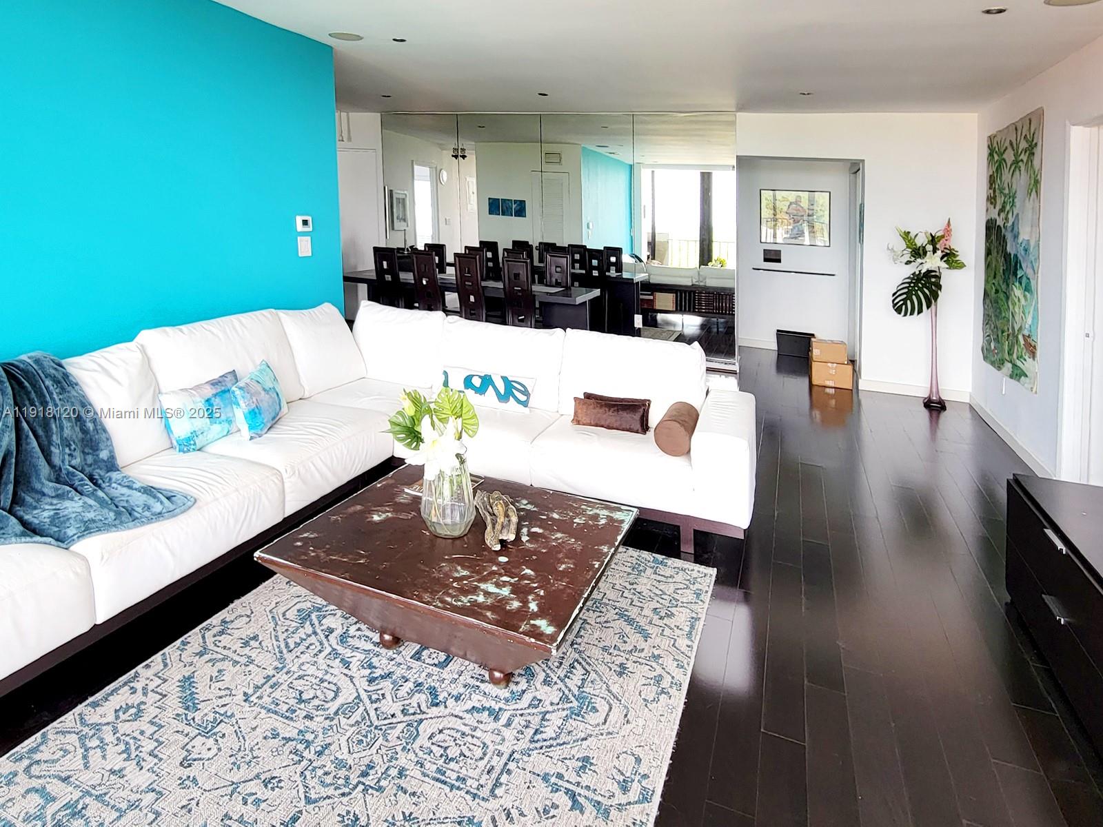 77 Crandon Boulevard, Unit 10A Key Biscayne, FL 33149 - Photo 4 of 15 a living room with furniture and wooden floor