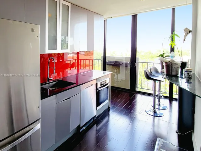 a kitchen with stainless steel appliances granite countertop a stove and wooden floor