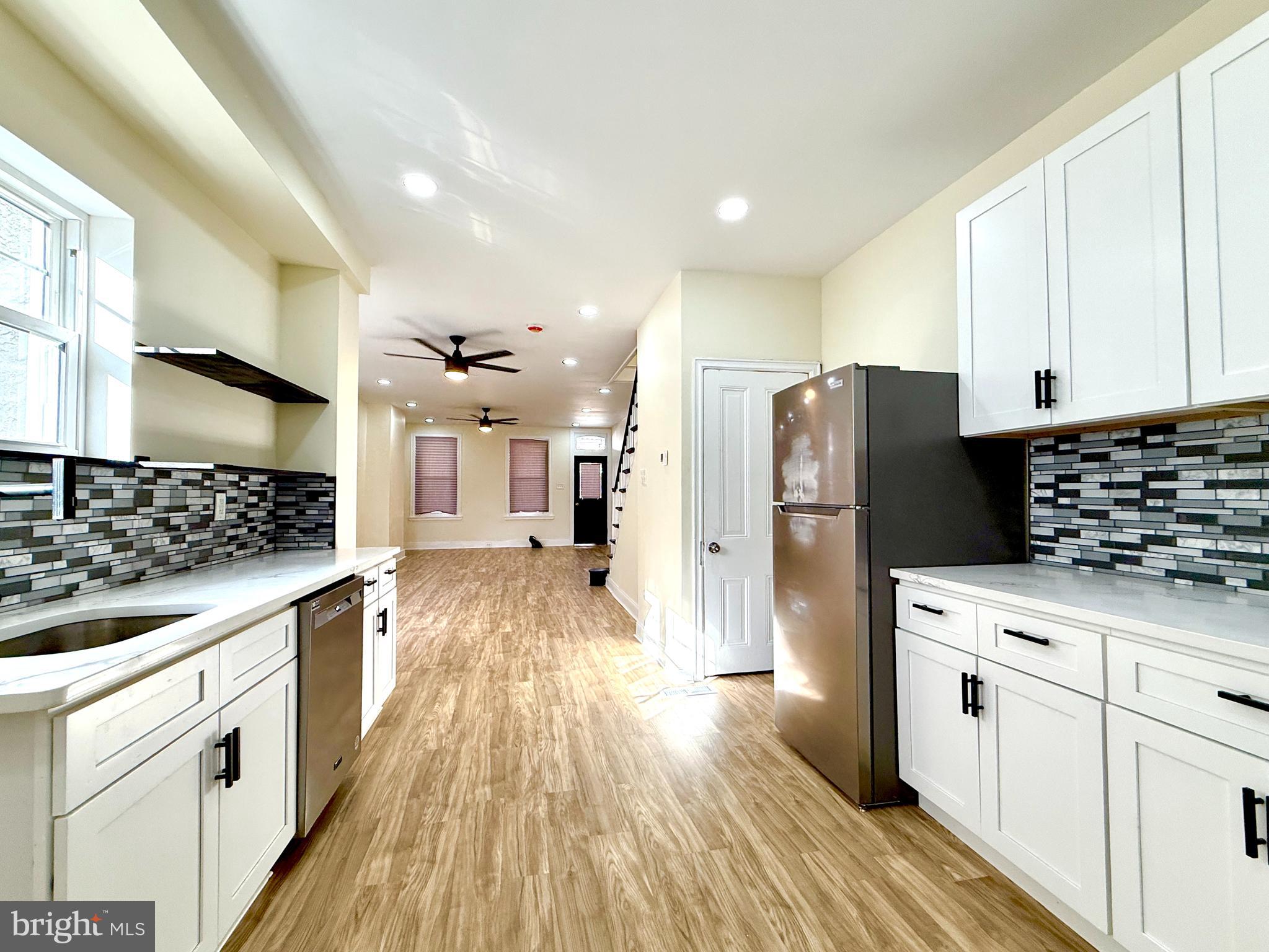 2913 West 6th Street Chester, PA 19013 - Photo 12 of 20 a kitchen with a refrigerator and a stove top oven