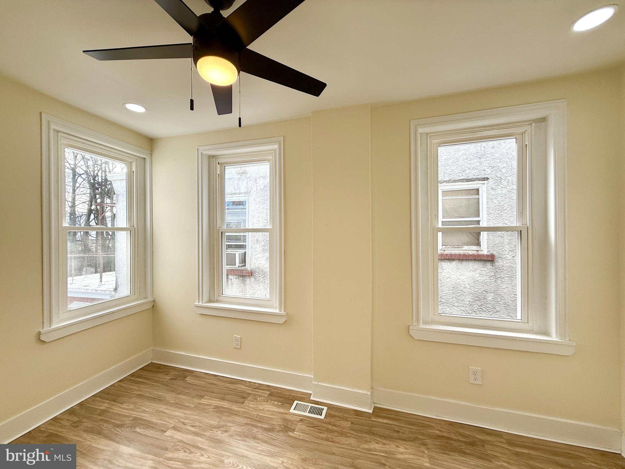 2913 West 6th Street Chester, PA 19013 - Photo 18 of 20 a view of an empty room with window and wooden floor