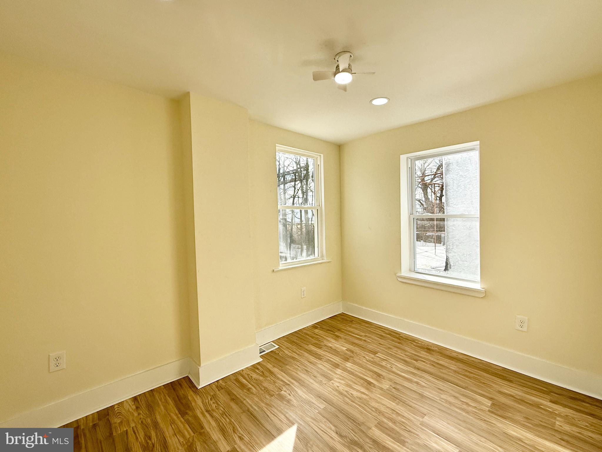2913 West 6th Street Chester, PA 19013 - Photo 20 of 20 a view of an empty room with wooden floor and a window